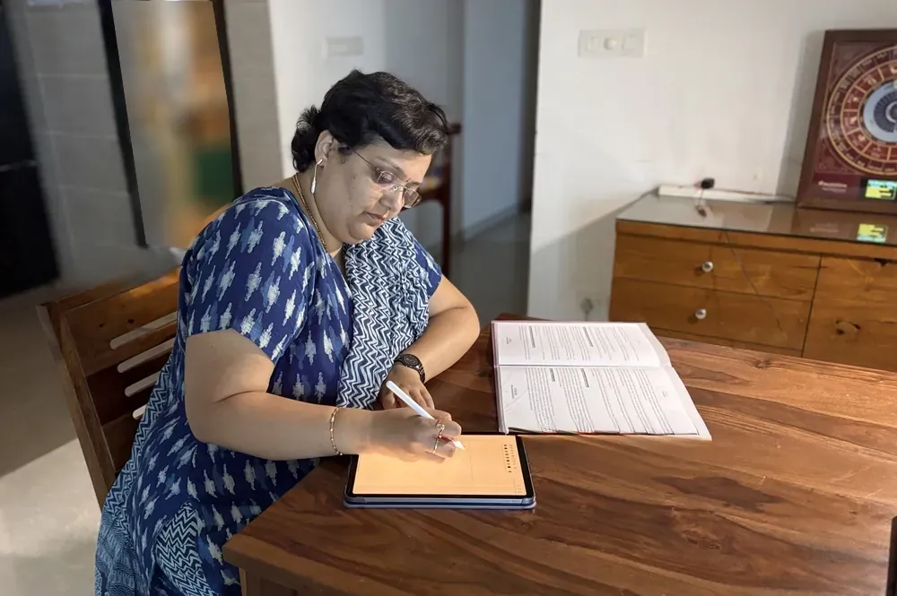 Dr. Chaittra studying a chart